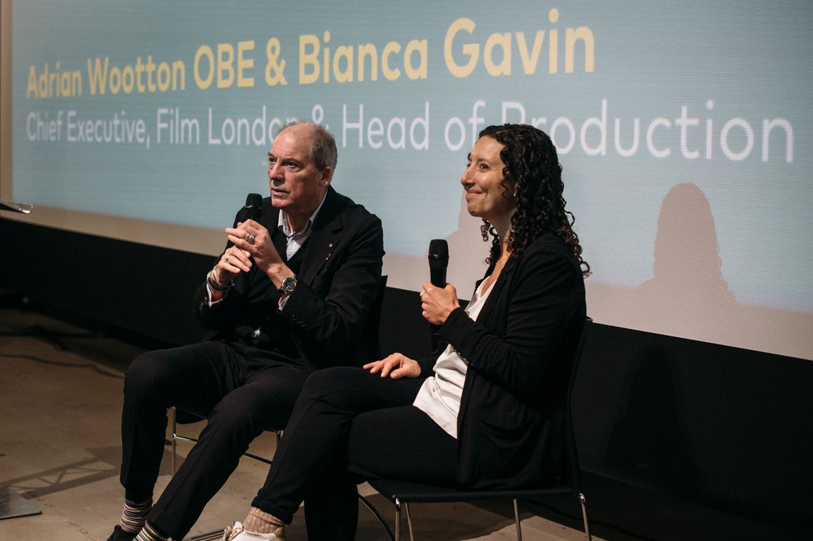 Adrian and Bianca sat on stage speaking