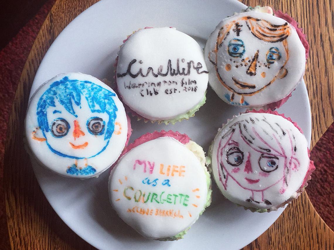 A plate of cupcakes with faces of characters from the film 'My Life as a Courgette'