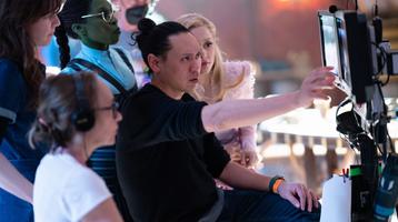 Film director John M. Chu behind the scenes of Wicked, a 2024 film.