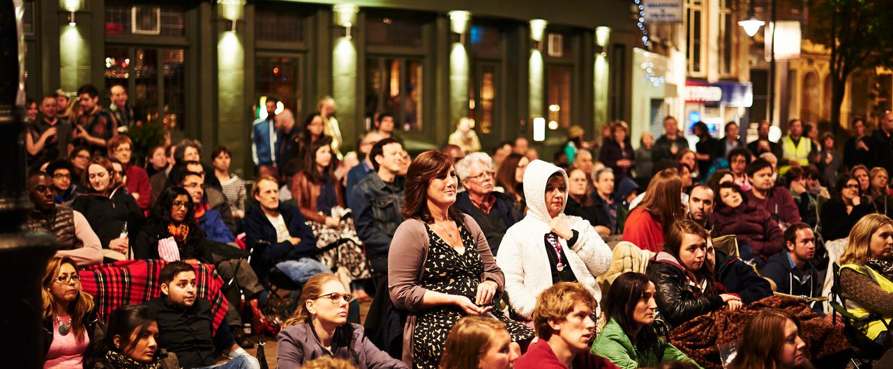 An audience watching an outdoor screening at Herne Hill