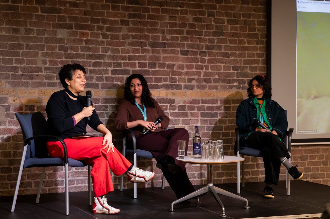 Three female panellists sat on stage
