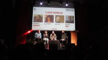 Four people sat on stage in front of screen at TNB XPO