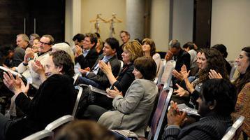 Audience members sat down and clapping