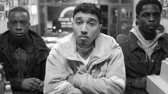 Still from Pirates. Three young men look directly at the camera.