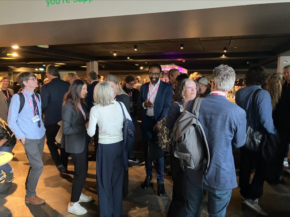 Group of people standing and talking at networking reception